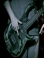 Image of Merge giving the finger while playing the bass